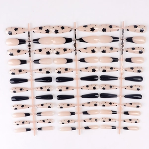 Detailed set of long ballet press-on nails with black floral and French tip designs