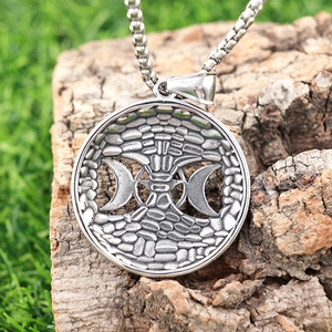 Vintage Tree of Life and Moon Goddess stainless steel pendant necklace on a natural tree bark