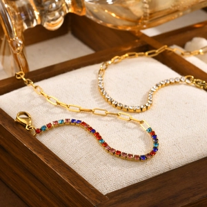 Detailed shot of gold-plated bracelets featuring rainbow and clear zircon crystals
