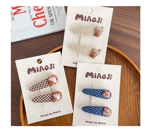 Detailed set of 6 fabric-covered animal and plaid hair clips on a wooden plate