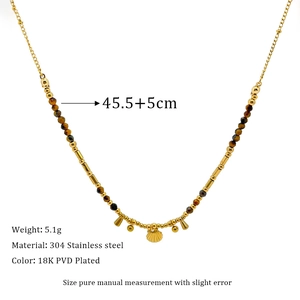 Detail of 18K gold-plated stainless steel necklace with brown beads and shell pendant