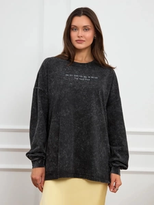 Close-up of vintage washed black cotton sweatshirt with white artistic calligraphy print