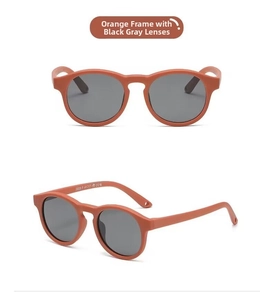 Detail view of round orange flexible silicone frame and gray polarized lenses for infants