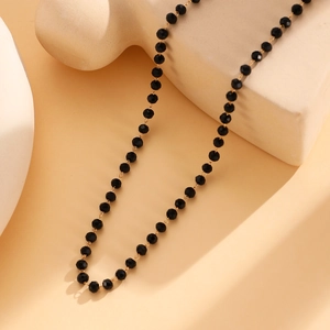 Close-up of black faceted beads and gold metal chain of this gothic butterfly necklace