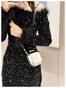Close-up of silver geometric octagonal clutch bag with metallic finish and chain strap