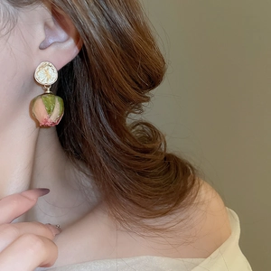 Detail of elegant pink rose bud earrings on model showcasing a graceful公主 style look
