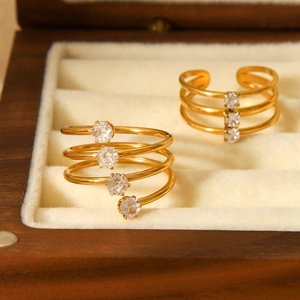 Minimalistische goldene Mehrschicht-Spiralringe mit Zirkonia auf einer Samtbox