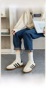 Close-up of white ribbed crew socks with elastic Lycra cuffs worn with sneakers