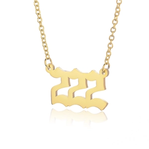 Golden stainless steel angel number 222 necklace with gothic pendant on white background