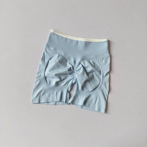 Detail showing high-waisted seamless light blue yoga shorts with scrunch butt lifting design