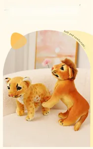 Realistic plush lion and leopard cub toys displayed on a soft white sofa set
