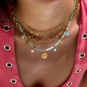 Close-up of layered 18K gold plated stainless steel necklace with blue beads and pearls