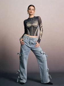 Detail of light blue cargo jeans with large side pockets and mesh printed top