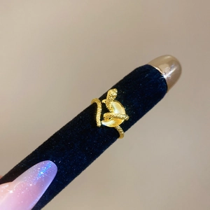 Macro shot of gold snake ring with zircon scales and a yellow cat eye stone focal point