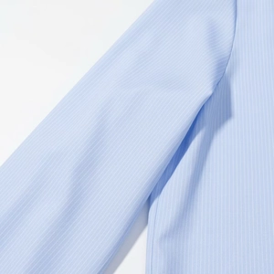 Close-up of light blue striped shirt showing fine fabric texture and shoulder stitching