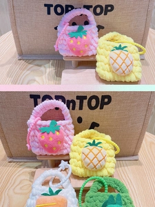 Detailed handmade crochet fruit coin purses including strawberry and pineapple designs