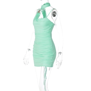 Detail of mint green bodycon dress with side ruching and butterfly pendant neck detail