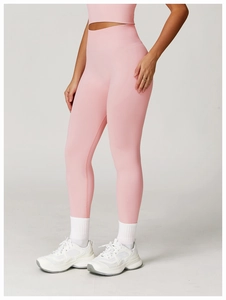 Close-up of pink high-waisted seamless yoga leggings with ribbed waistband for tummy control