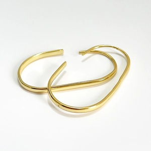 Minimalist 925 sterling silver U-shaped hoop earrings with a sleek golden metallic finish