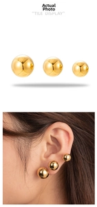 Three-piece set of polished gold ball stud earrings in various sizes for a layered look