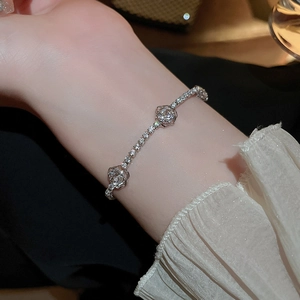 Detailed close-up of a silver floral bracelet with sparkling stones on a wrist