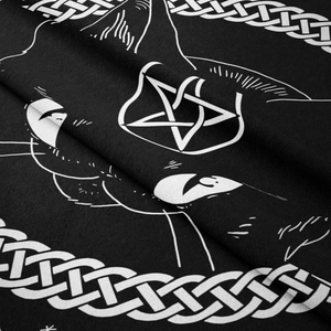 Detail of bohemian black cat tapestry showing fine fabric texture and white Celtic knots
