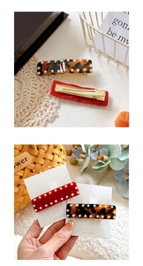 Detailed macro view of acetate hair clips with pearl accents and gold metal duckbill base