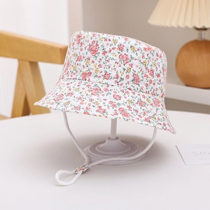 Detail of floral infant bucket hat with pink flower patterns and white chin strap