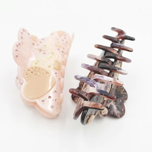 Acetate hair claw set with heart patterns, rhinestones, and purple marble finish