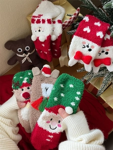 Close-up of thick coral fleece Christmas socks featuring cute reindeer and bear patterns