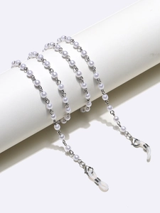 Close-up of pearl eyewear chain with silver metal links and silicone loops on display