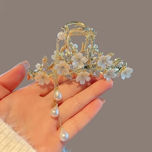 Elegant gold flower hair claw clip with white petals and dangling pearl tassels for women
