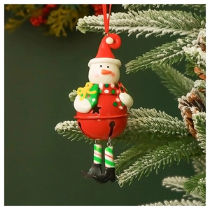 Close-up of a festive snowman metal bell ornament hanging on a snowy Christmas tree branch