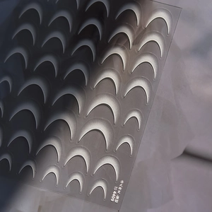 Macro detail of ultra-thin French gradient nail stickers with silver crescent moon patterns