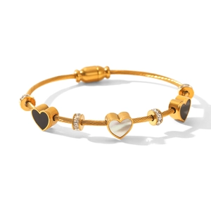 Detail of 18K gold stainless steel wire bracelet with heart charms and crystal beads