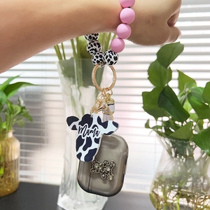 Detail of cow print beads wristlet with pink silicone beads and mama cow charm