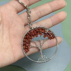 Detail of tree of life keychain featuring silver wire wrap and red jasper stones