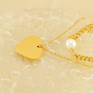 Vintage double layer necklace with gold heart pendant and white pearls on gold chains
