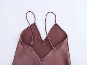 Detail of adjustable thin straps and deep V-back on purple silk satin slip dress