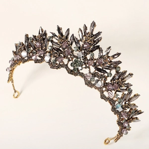 Macro shot of antique gold bridal crown with gray and purple rhinestones and side loops