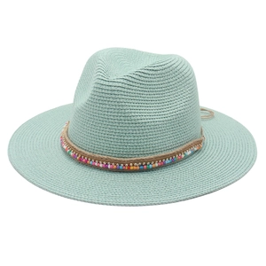 Detail of mint green woven straw hat with colorful beads and natural jute rope cord