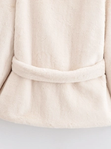 Detail shot of beige faux fur jacket back with soft texture and matching waist belt