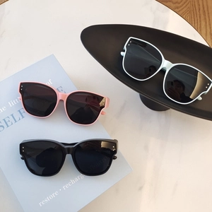 Kids vintage cat-eye sunglasses in pink, black, and white colors for UV protection