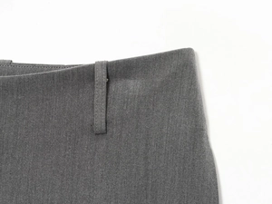 Close-up of the waistband and belt loop detail on gray tailored casual shorts