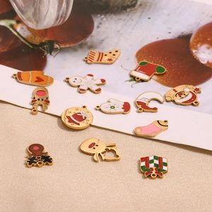 Detail view of 14K gold plated Christmas charms including Santa, reindeer and snowman pendants