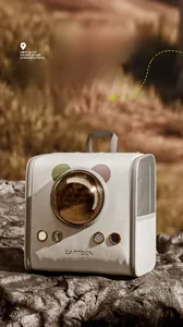 Macro shot of breathable cat backpack with space capsule window on outdoor rocks