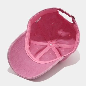 Detail view of pink washed cotton baseball cap interior showing sweatband and sewing