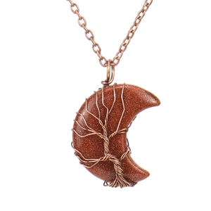 Detail of wire-wrapped tree of life on gold sandstone crescent moon pendant necklace