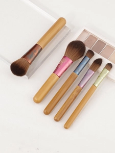 Detail of 5-piece bamboo handle makeup brushes with floral printed colorful metal ferrules