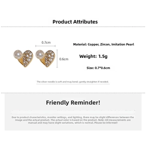 Detail view of heart-shaped earrings with zircon and pearls showing 0.7cm dimensions